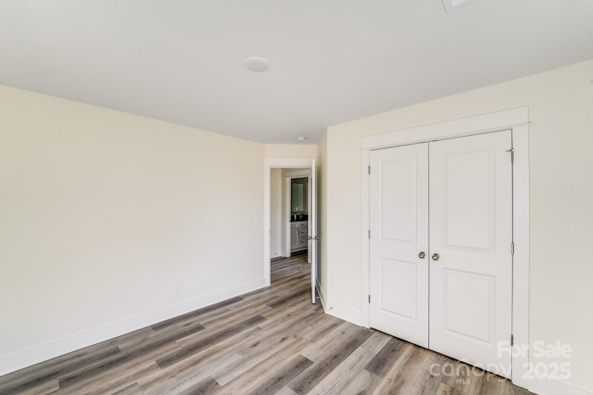 212 Sugar Hill Road Troutman, NC 28166 - Photo 35 of 47 an empty room with wooden floor and closet