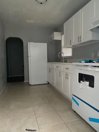 a kitchen with cabinets and appliances