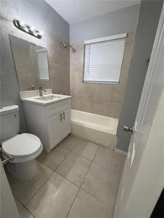 a bathroom with a bathtub a toilet a sink and mirror