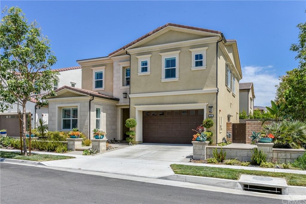 18 Tomango Lake Forest, CA 92630 - Photo 2 of 45 a front view of a house with a yard and garage