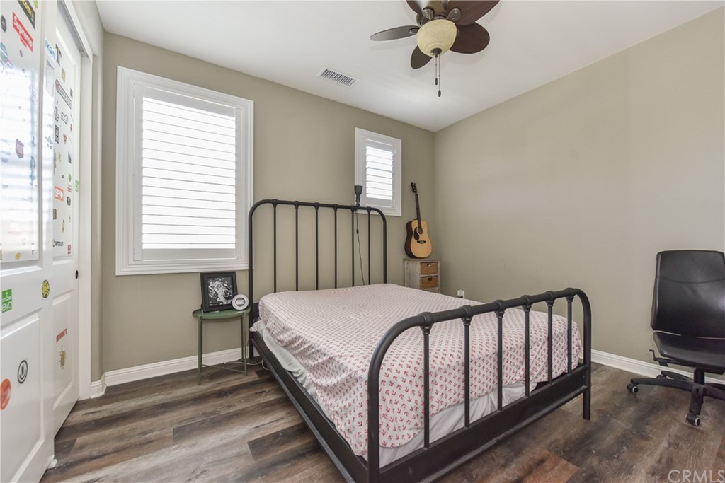 18 Tomango Lake Forest, CA 92630 - Photo 22 of 45 a bedroom with a bed a chandelier and a window