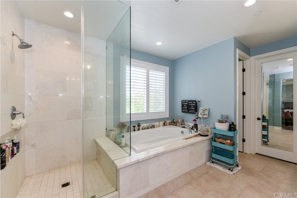 18 Tomango Lake Forest, CA 92630 - Photo 35 of 45 a spacious bathroom with a tub sink shower and mirror