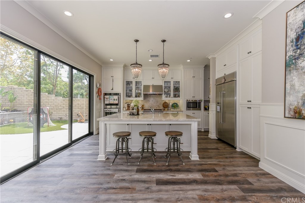18 Tomango Lake Forest, CA 92630 - Photo 6 of 45 a kitchen with kitchen island granite countertop a table chairs refrigerator and sink