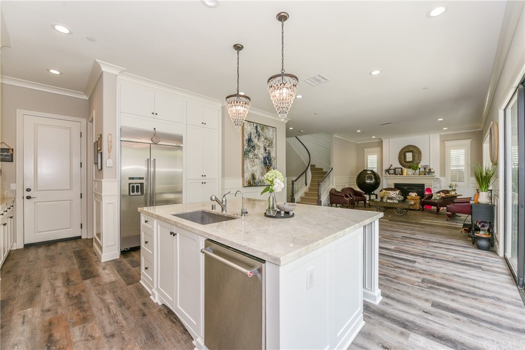 18 Tomango Lake Forest, CA 92630 - Photo 8 of 45 a large kitchen with stainless steel appliances a stove center island with wooden floor and chandelier