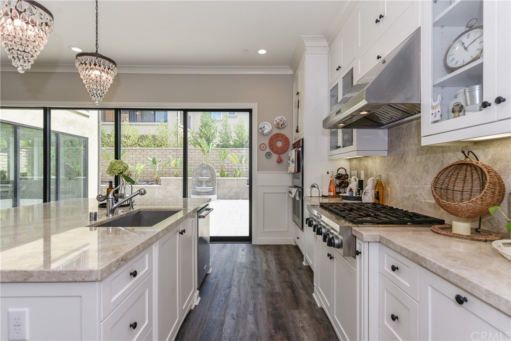 18 Tomango Lake Forest, CA 92630 - Photo 9 of 45 a kitchen with granite countertop a stove a sink a refrigerator and wooden floor