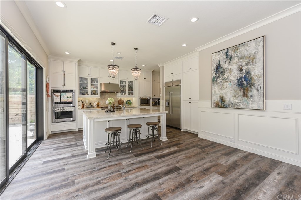 18 Tomango Lake Forest, CA 92630 - Photo 10 of 45 a view of living room kitchen with stainless steel appliances furniture large window and wooden floor