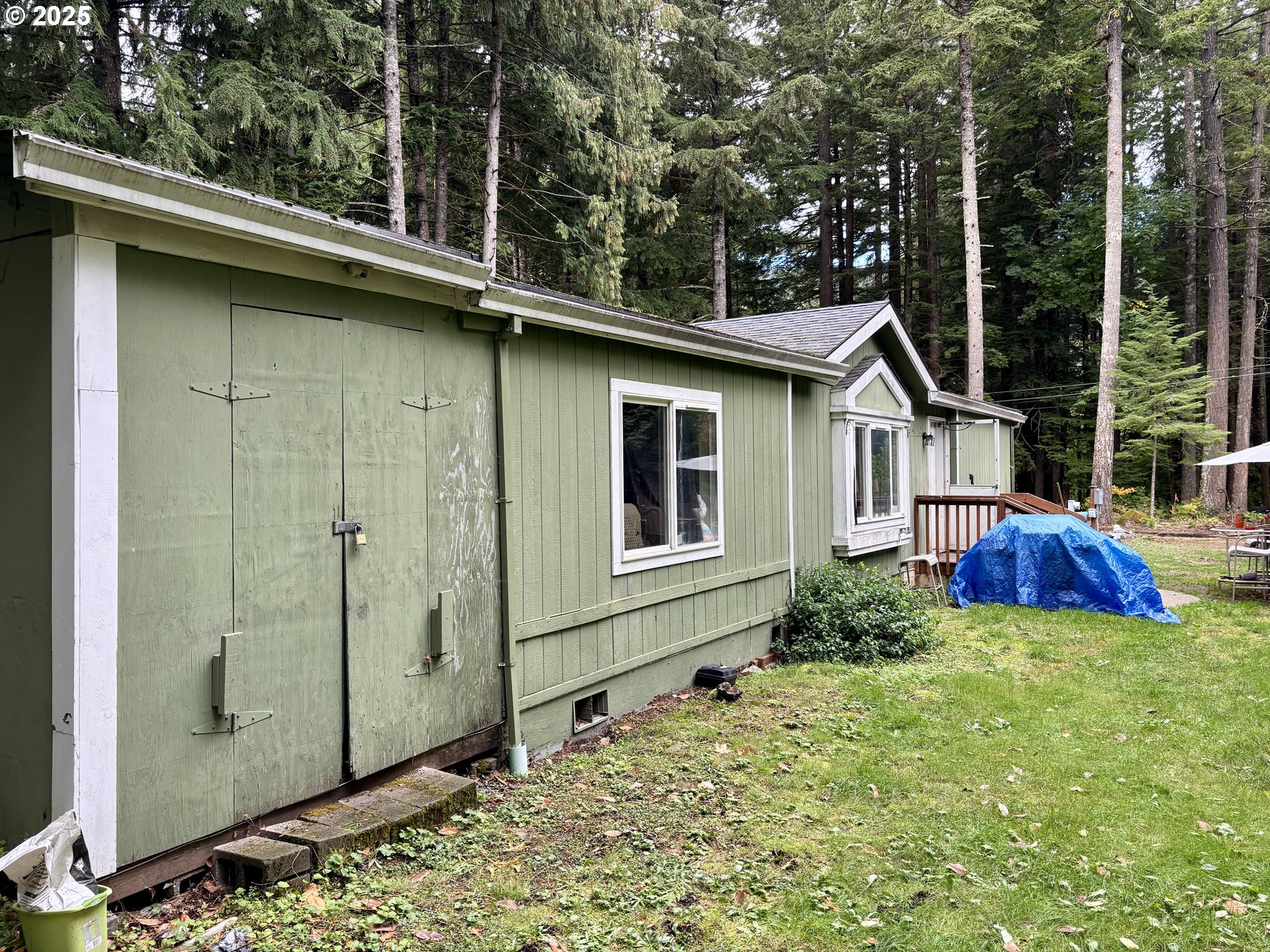 69300 East Vine Maple Drive Rhododendron, OR 97049 - Photo 5 of 16 a view of a house with a yard and sitting area