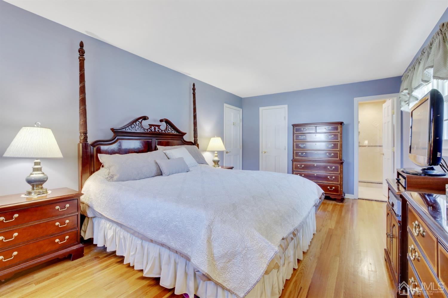 975 Carteret Road Bridgewater, NJ 08807 - Photo 14 of 25 a bedroom with a bed and wooden floor