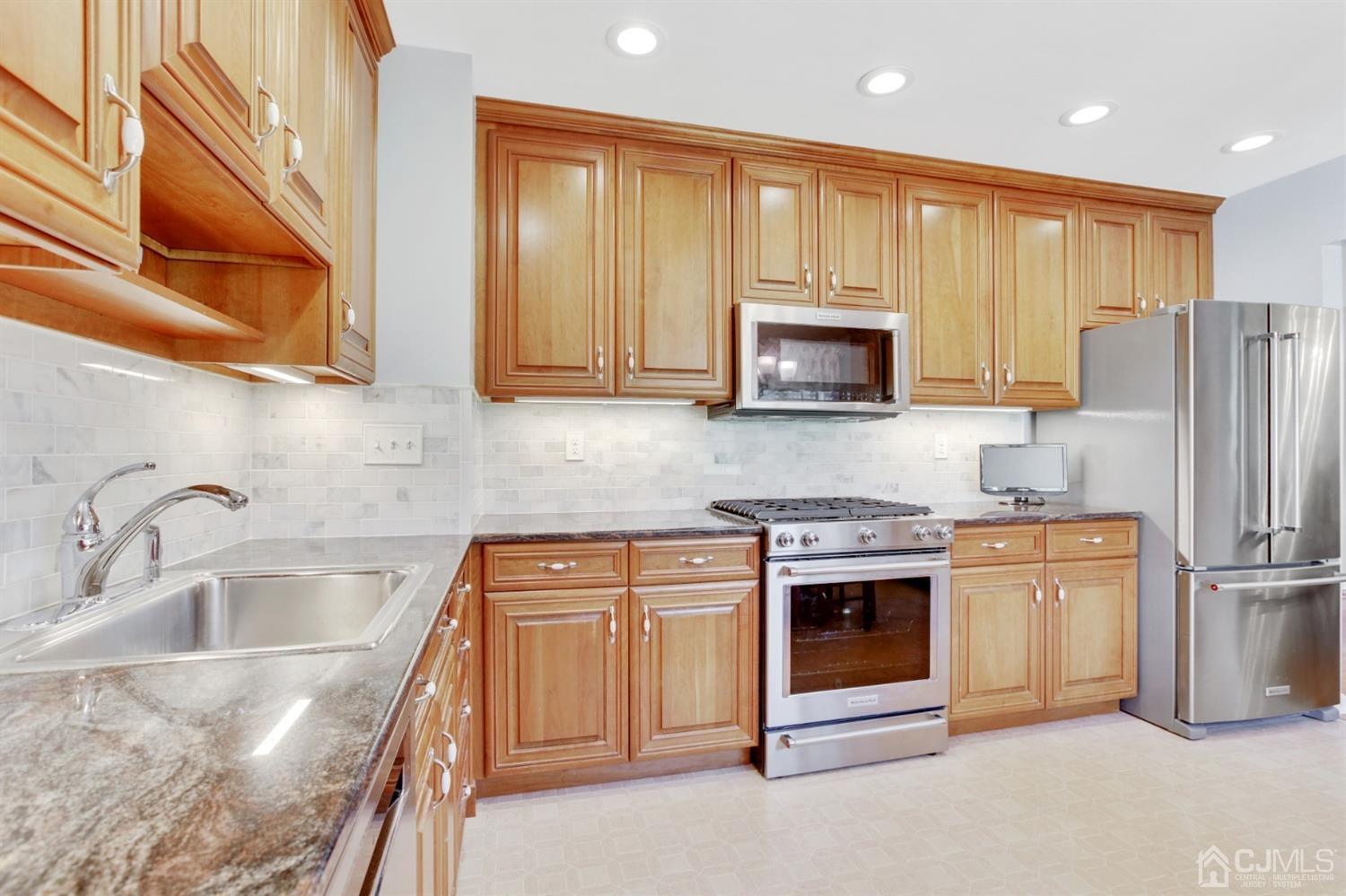 975 Carteret Road Bridgewater, NJ 08807 - Photo 8 of 25 a kitchen with stainless steel appliances granite countertop a stove microwave and refrigerator