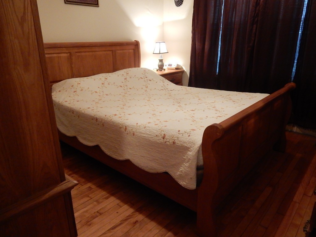 63 Bucknam Street Everett, MA 02149 - Photo 12 of 28 a bed sitting in a bedroom and dresser