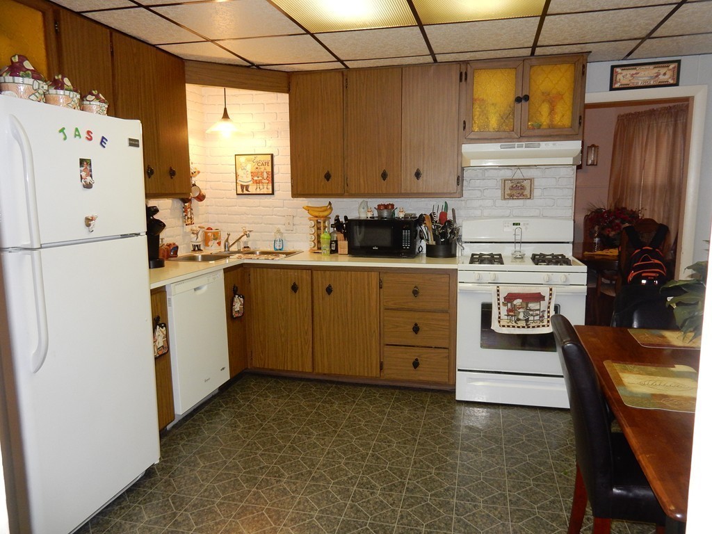 63 Bucknam Street Everett, MA 02149 - Photo 14 of 28 a kitchen with cabinets stainless steel appliances and a window