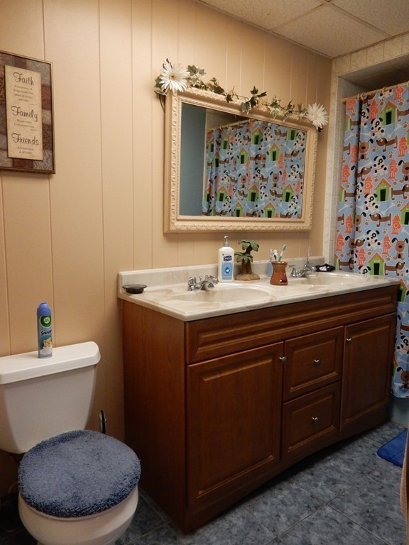 63 Bucknam Street Everett, MA 02149 - Photo 16 of 28 a bathroom with a toilet a sink and a mirror