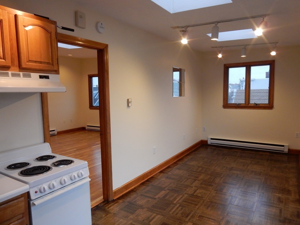 63 Bucknam Street Everett, MA 02149 - Photo 18 of 28 a kitchen with a refrigerator and a stove