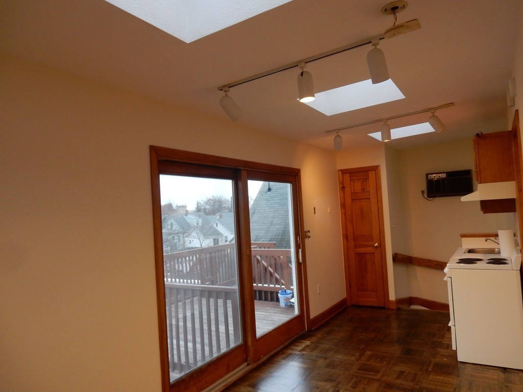 63 Bucknam Street Everett, MA 02149 - Photo 19 of 28 a view of a kitchen with refrigerator and wooden floor