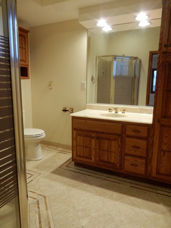 63 Bucknam Street Everett, MA 02149 - Photo 23 of 28 a bathroom with a sink and a mirror