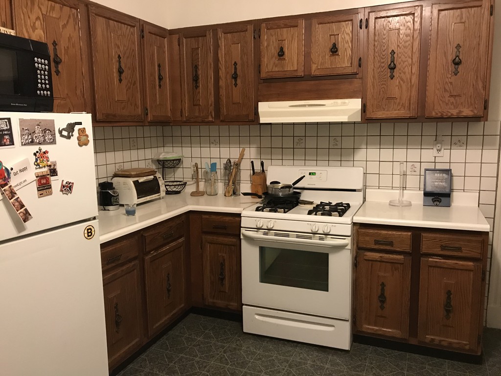 63 Bucknam Street Everett, MA 02149 - Photo 26 of 28 a kitchen with cabinets appliances and a sink