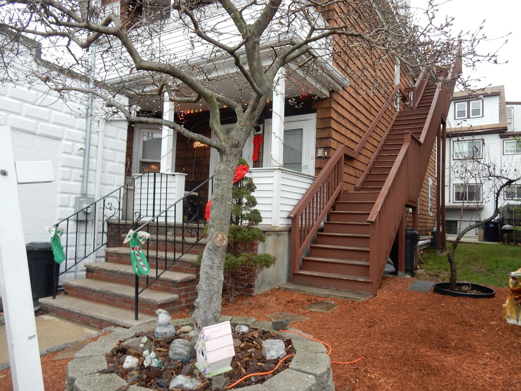 63 Bucknam Street Everett, MA 02149 - Photo 3 of 28 a view of a house with a street