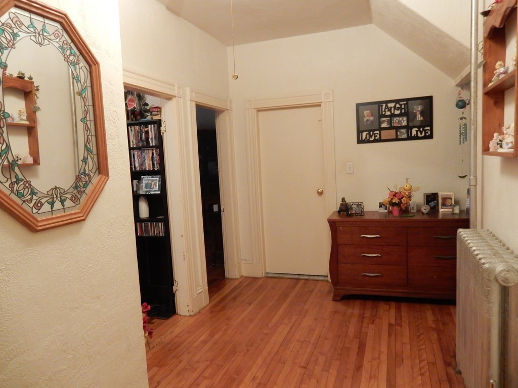 63 Bucknam Street Everett, MA 02149 - Photo 8 of 28 a room with painting and a table