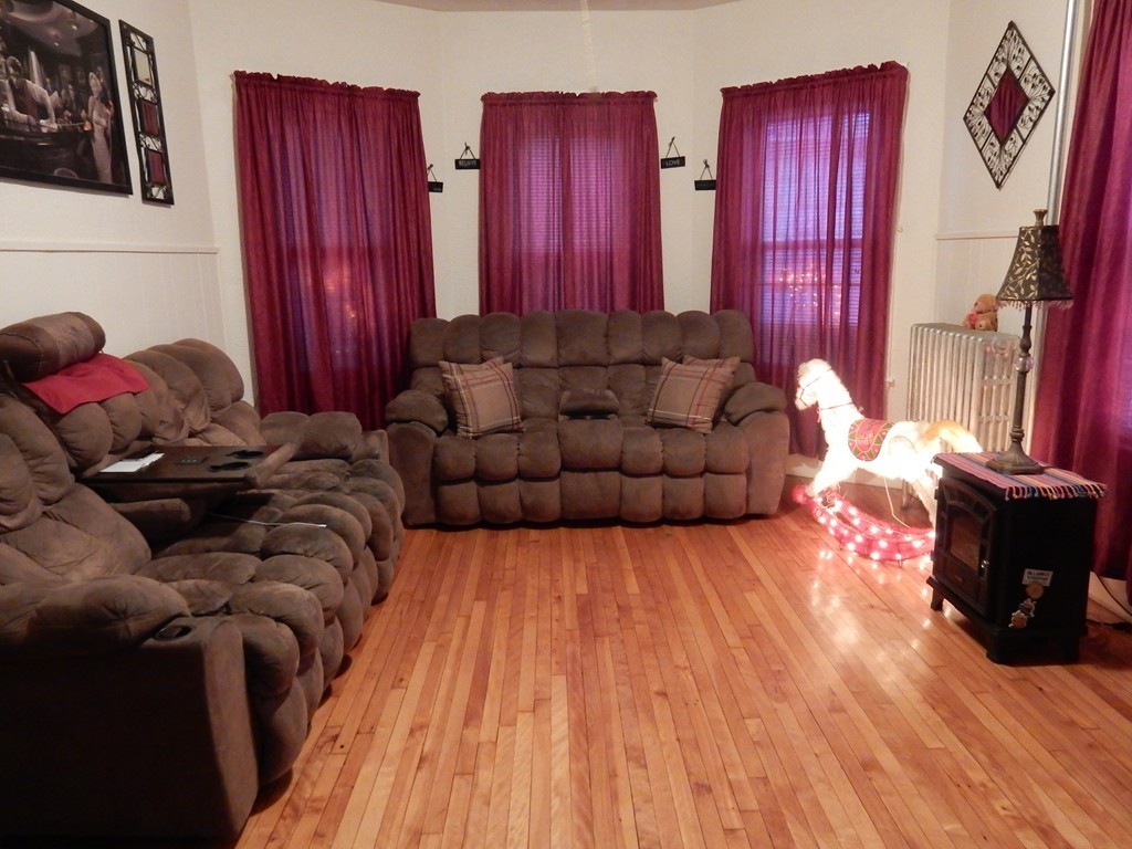 63 Bucknam Street Everett, MA 02149 - Photo 9 of 28 a living room with furniture window and wooden floor