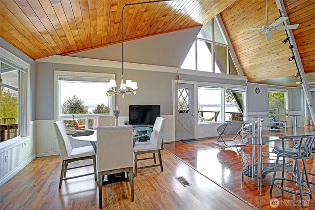 a dining room with furniture wooden floor and a chandelier