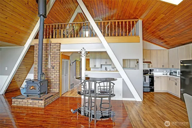 a view of a living room with wooden floor and stairs