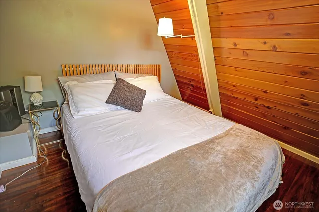 a large bed sitting in a bedroom next to a window