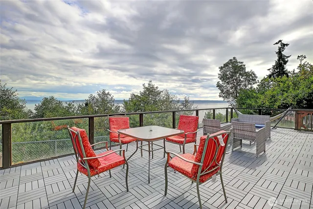 an outdoor sitting area with couch and wooden floor