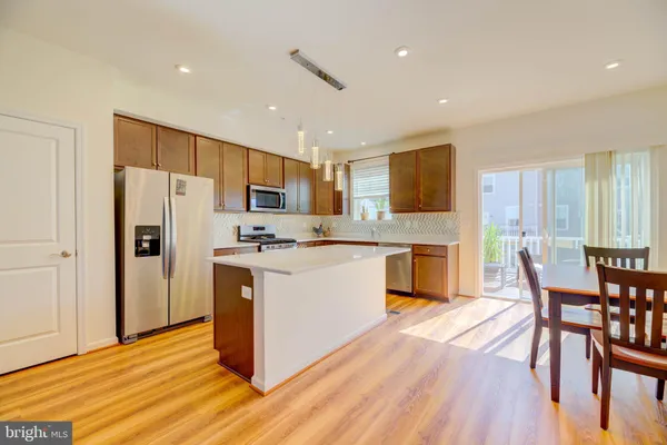a kitchen with wooden floors and refrigerator
