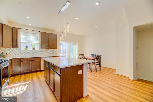 a kitchen with a sink cabinets and wooden floor