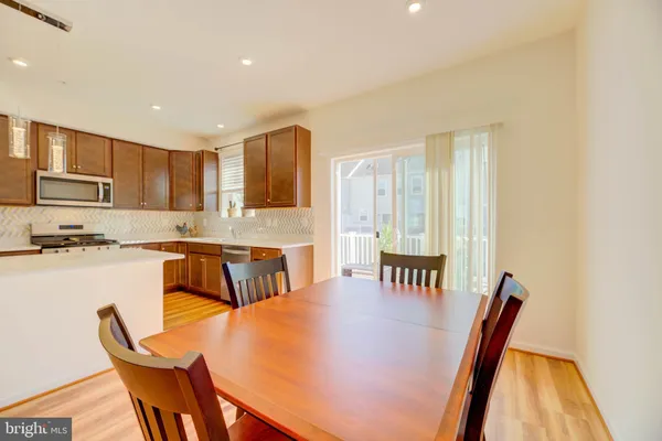 a kitchen with a table chairs sink and microwave