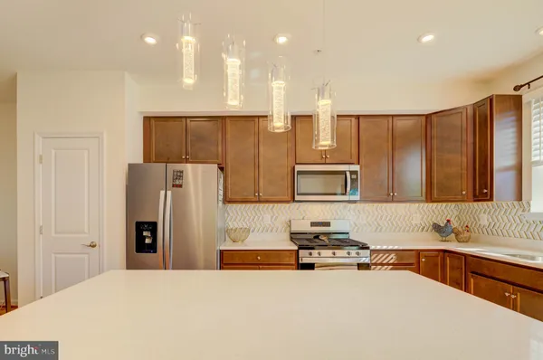 a kitchen with stainless steel appliances wooden floors and wooden cabinets