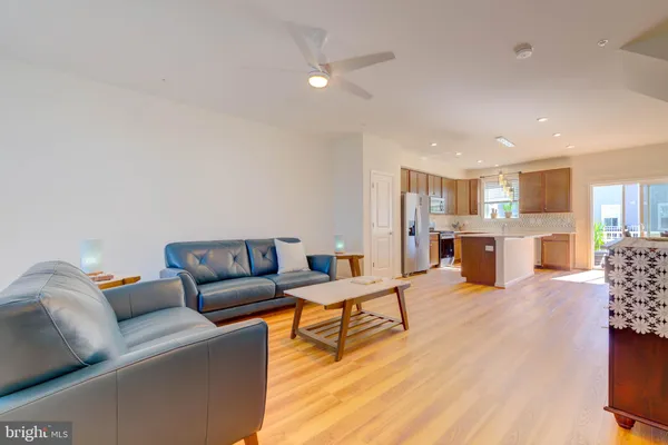 a living room with furniture and kitchen view