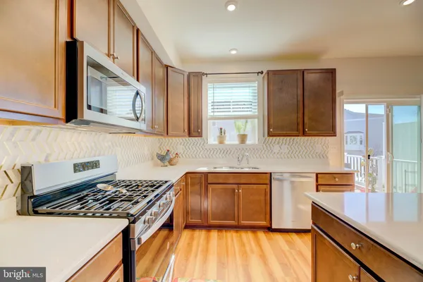 a kitchen with stainless steel appliances granite countertop a stove and a sink