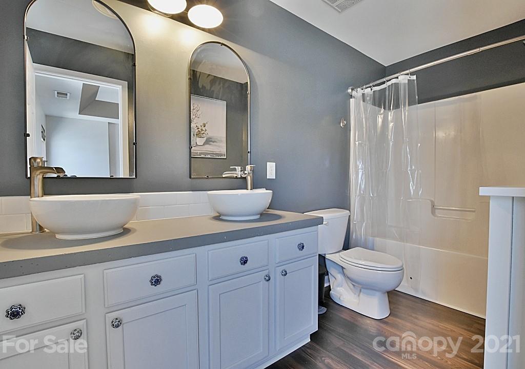 821 Dillard Road Rock Hill, SC 29730 - Photo 14 of 21 a bathroom with a granite countertop toilet sink and mirror