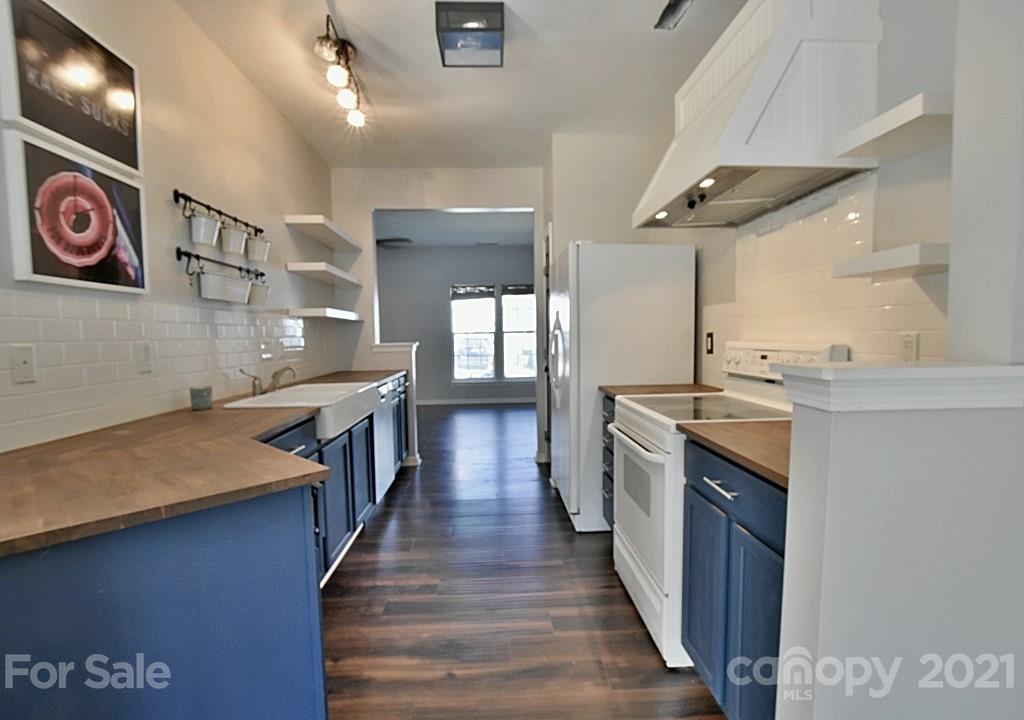 821 Dillard Road Rock Hill, SC 29730 - Photo 8 of 21 a kitchen with stainless steel appliances granite countertop lots of counter top space and wooden floor