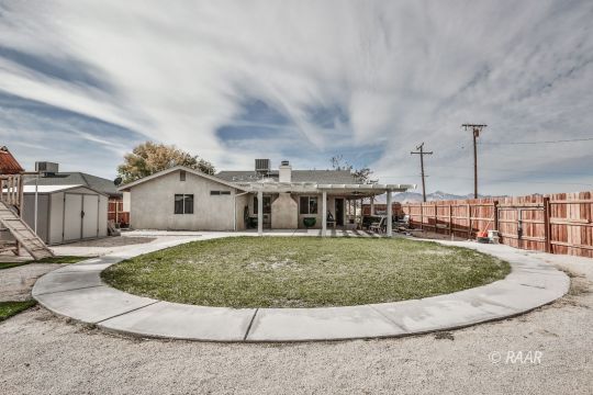 340 North Kern Street Ridgecrest, CA 93555 - Photo 33 of 33 a view of a house with a swimming pool and sitting area