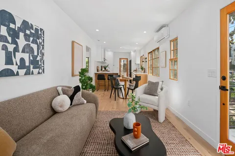 a living room with furniture and a potted plant
