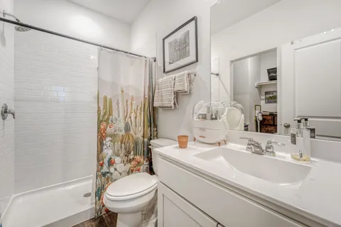 a bathroom with a sink toilet and shower