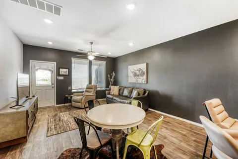 a view of a dining room with furniture and a chandelier