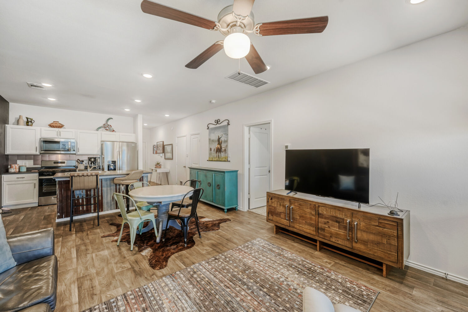 549 Arnold Loop, Unit A Kyle, TX 78640 - Photo 6 of 16 a living room with furniture and a flat screen tv