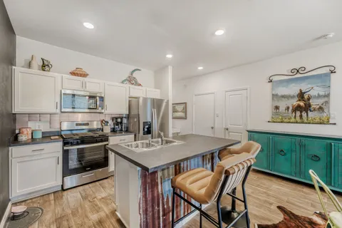 a kitchen that has a table and chairs in it