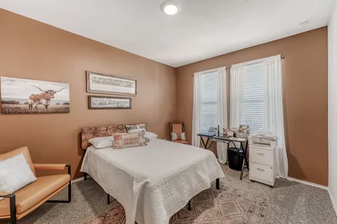 a bedroom with a bed and a couch