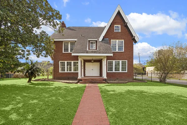 a front view of a house with a yard
