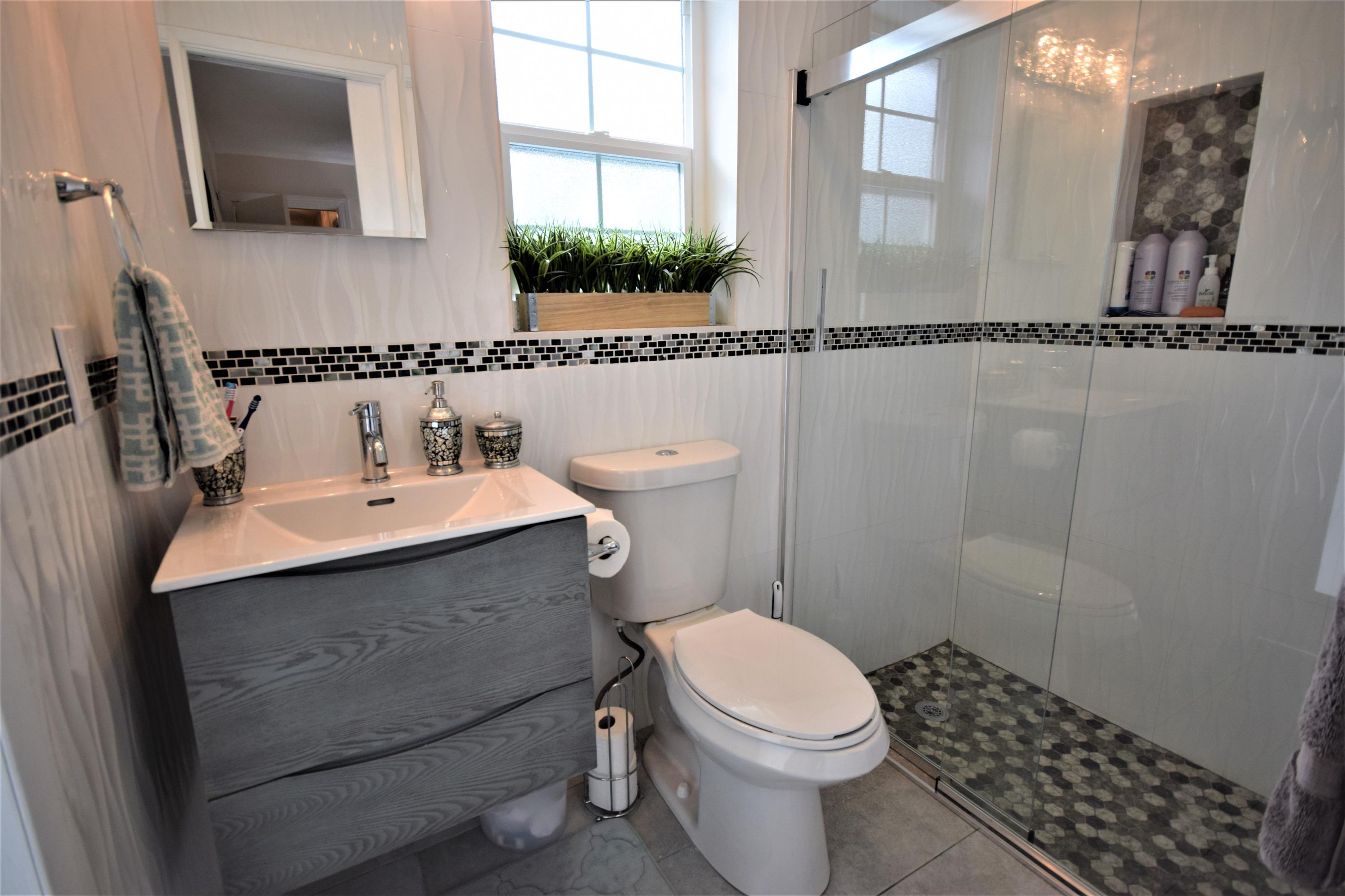2770 Northeast 25th Terrace Boca Raton, FL 33431 - Photo 13 of 34 a bathroom with a sink toilet and mirror