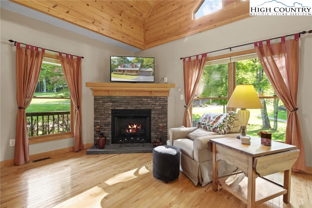 105 Old Field Road Beech Mountain, NC 28604 - Photo 18 of 43 a living room with furniture and a fireplace