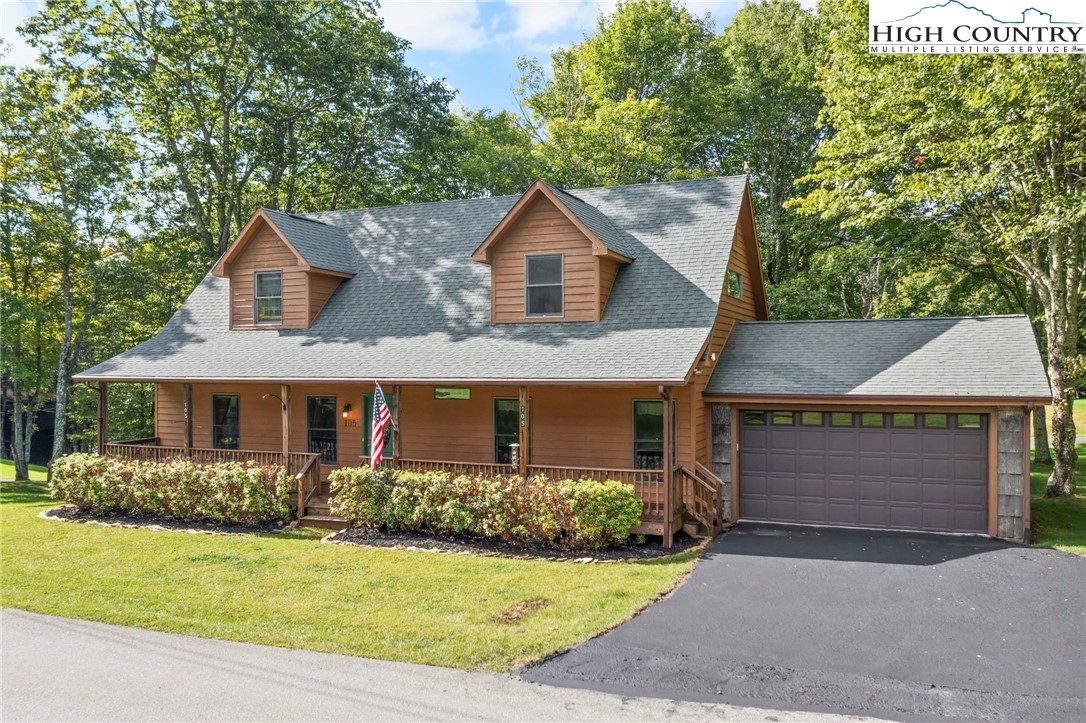 105 Old Field Road Beech Mountain, NC 28604 - Photo 2 of 43 a front view of a house with a yard and garage