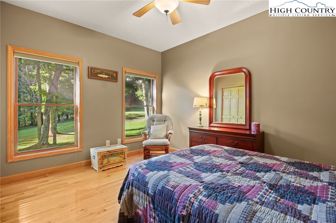 105 Old Field Road Beech Mountain, NC 28604 - Photo 27 of 43 a bedroom with a bed and wooden floor