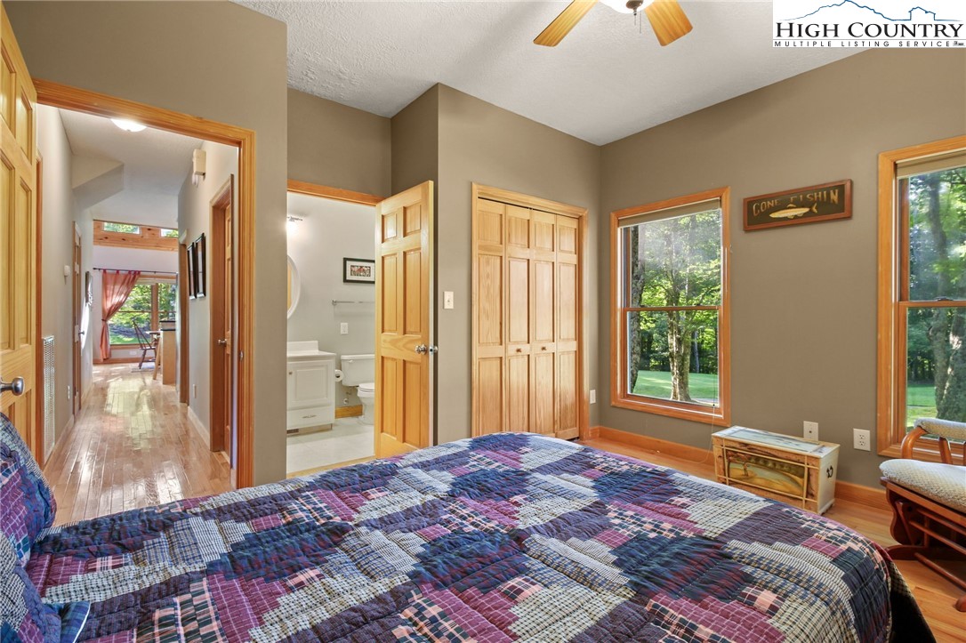 105 Old Field Road Beech Mountain, NC 28604 - Photo 28 of 43 a bedroom with a bed and large windows