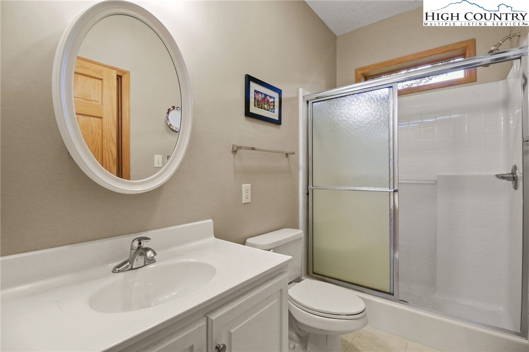 105 Old Field Road Beech Mountain, NC 28604 - Photo 29 of 43 a bathroom with a sink toilet and a mirror