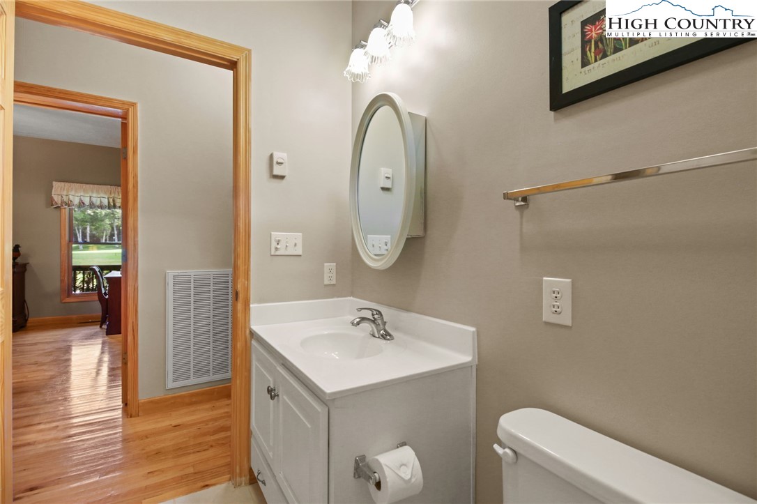 105 Old Field Road Beech Mountain, NC 28604 - Photo 30 of 43 a bathroom with a toilet a sink and mirror
